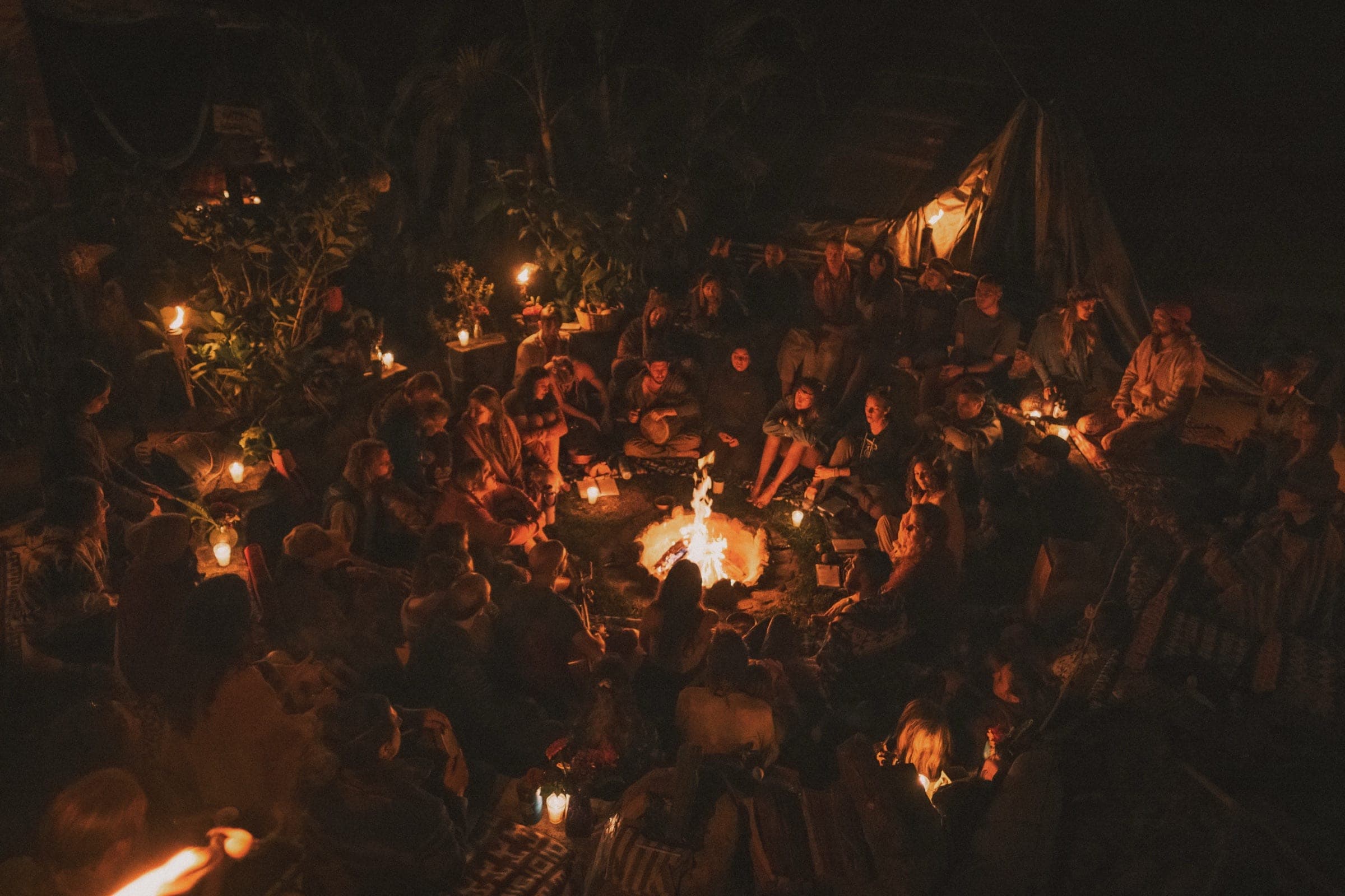 Candlelit night fire circle at a HeartSong gathering
