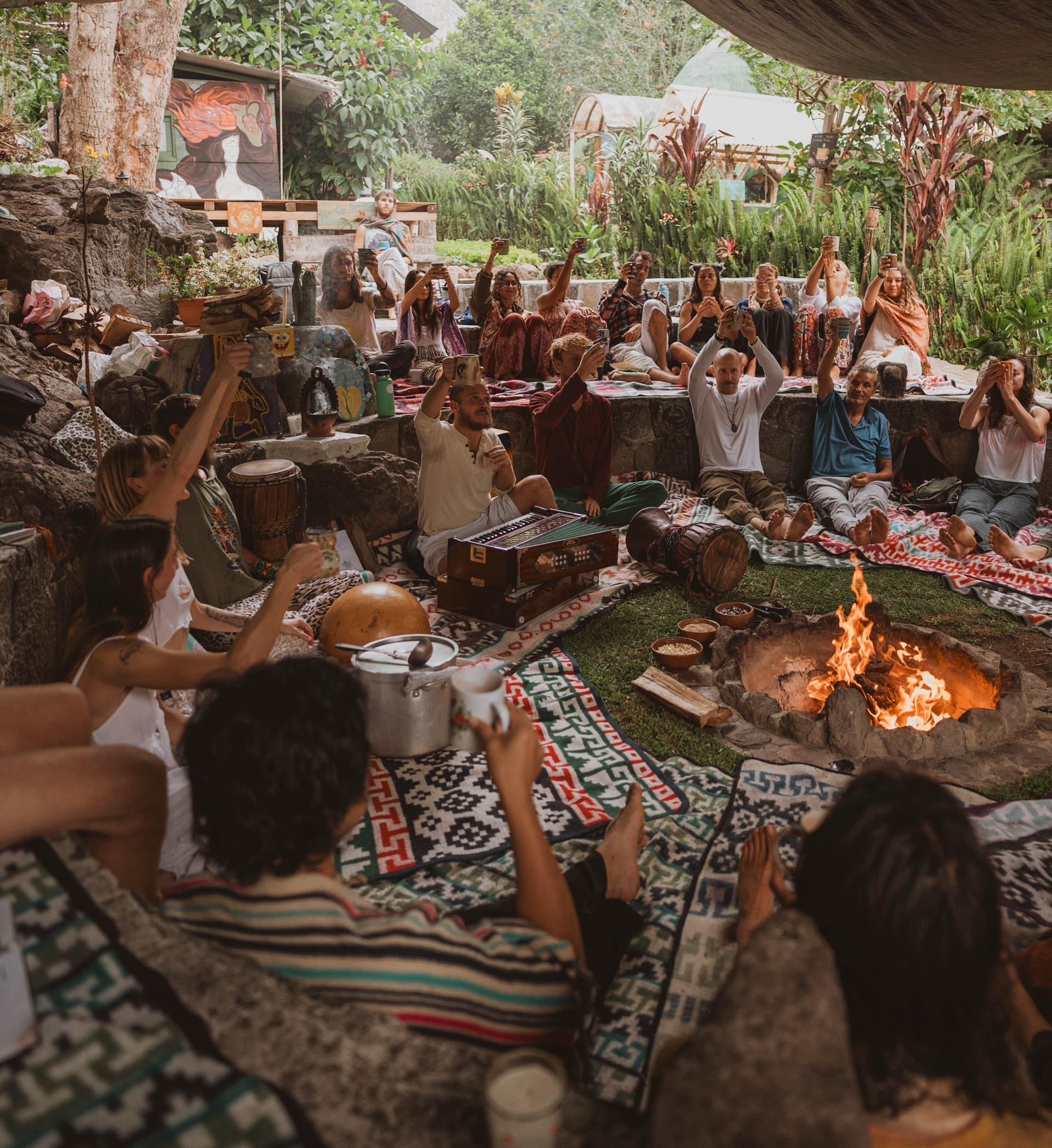 Guests raise mugs around the sacred fire at Mystical Yoga Farm