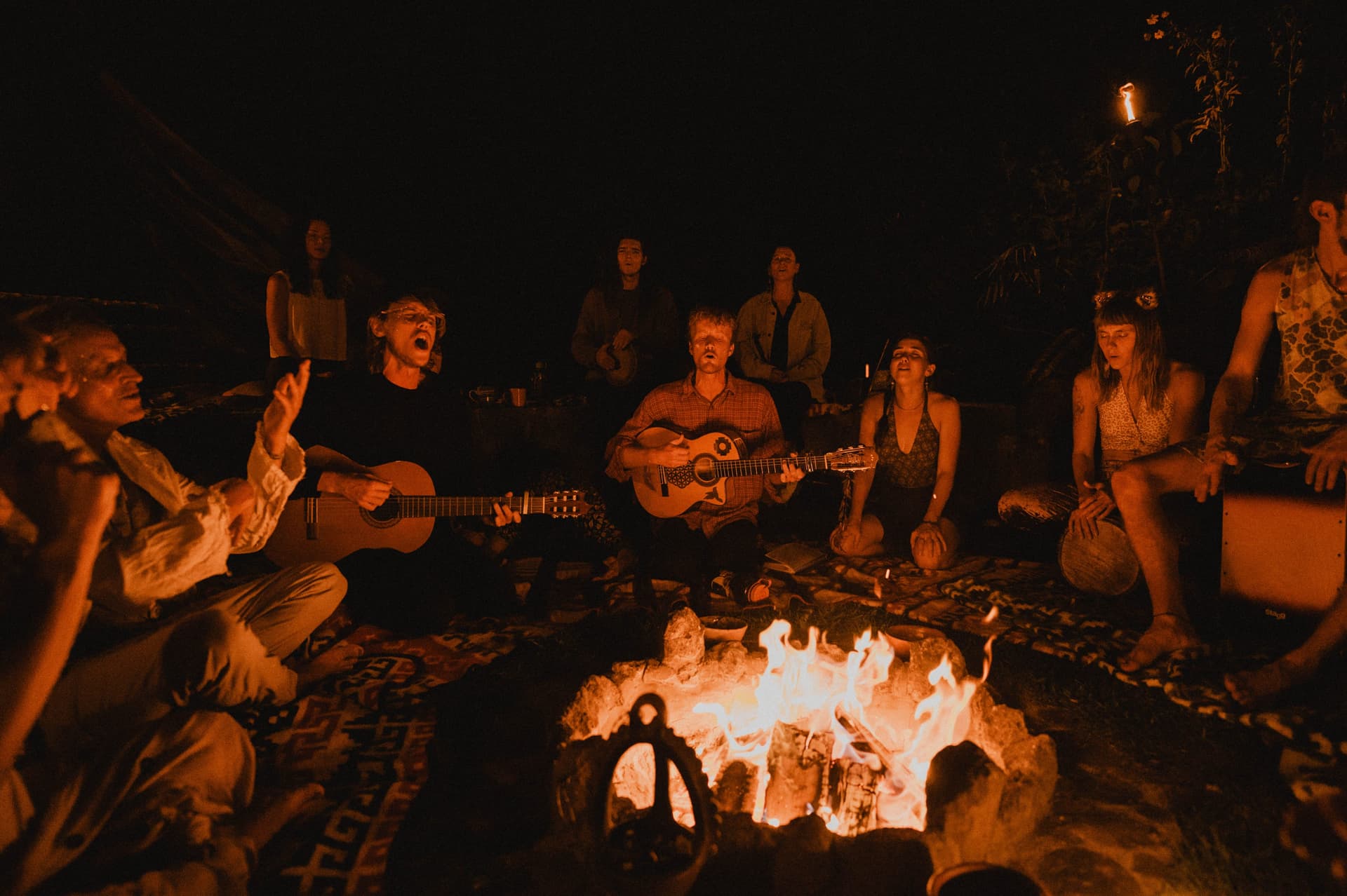 Night fire circle with guitar and song at Mystical Yoga Farm