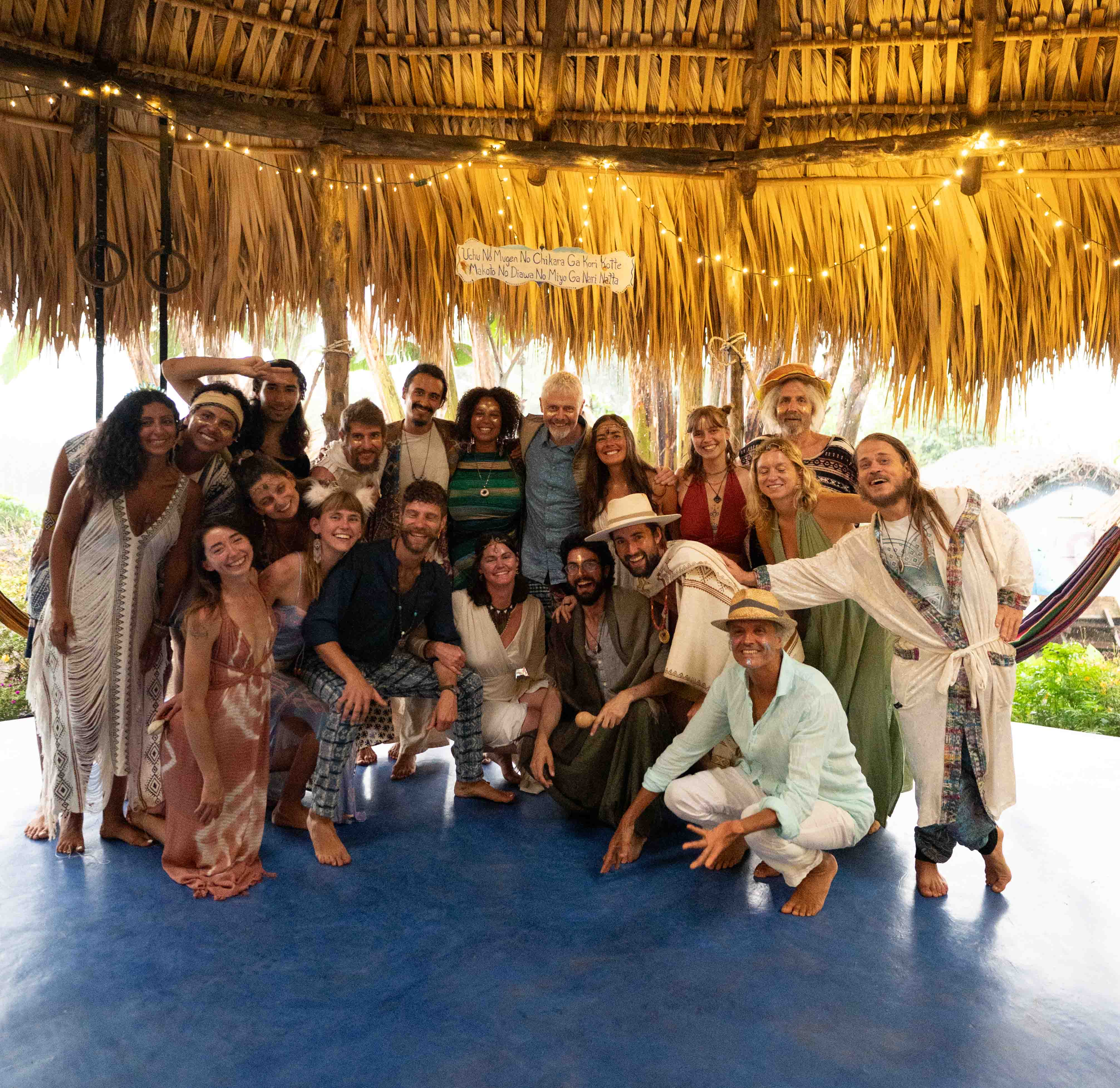 Light Leaders community gathered under a thatched rancho at Mystical Yoga Farm