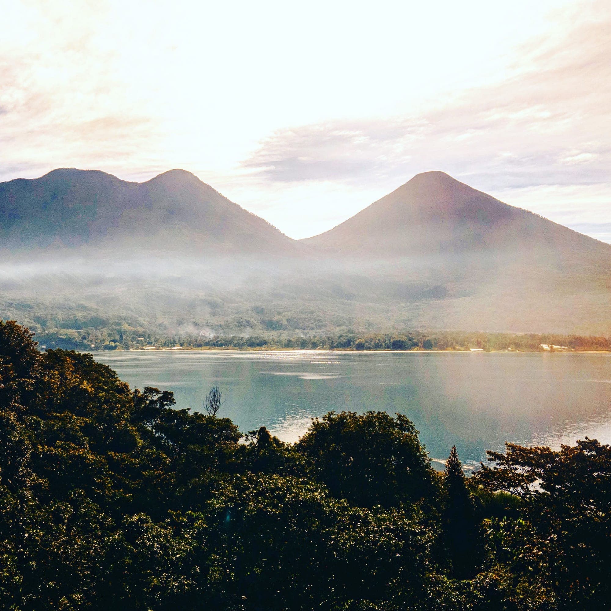 Morning mist over Lake Atitlán and the volcanoes, seen from the farm